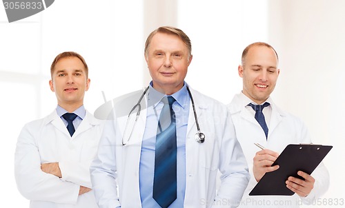 Image of group of smiling male doctors in white coats