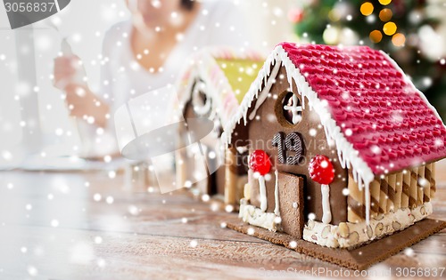 Image of close up of woman making gingerbread houses