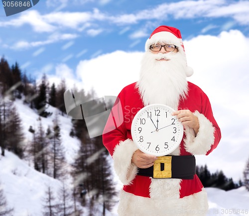 Image of man in costume of santa claus with clock