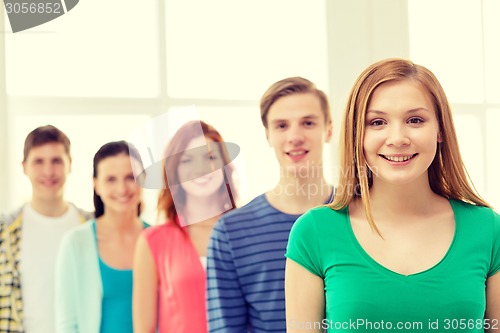 Image of smiling students with teenage girl in front
