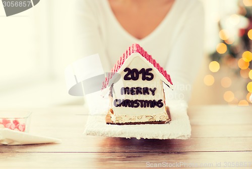 Image of close up of woman showing gingerbread house