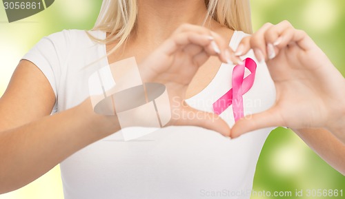 Image of close up of woman and pink cancer awareness ribbon