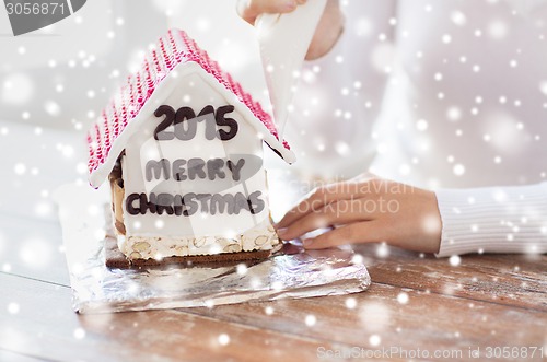 Image of close up of woman making gingerbread houses