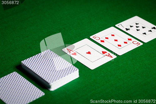 Image of playing cards on green table surface