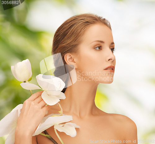 Image of beautiful young woman with orchid flowers