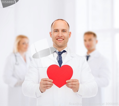 Image of smiling male doctor with red heart