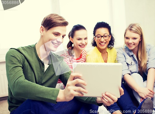 Image of smiling students making picture with tablet pc