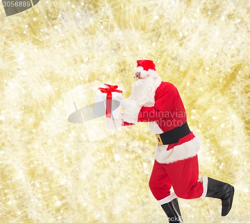 Image of man in costume of santa claus with gift box