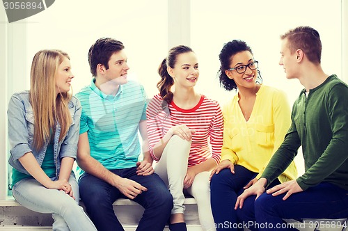 Image of five smiling teenagers having fun at home