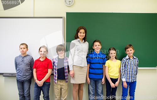 Image of group of school kids and teacher in classroom