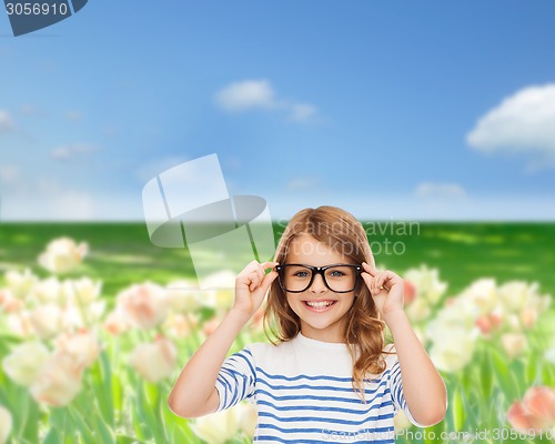 Image of smiling cute little girl with black eyeglasses