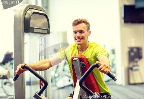 Image of smiling man exercising in gym