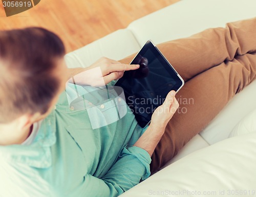 Image of close up of man with tablet pc computer at home