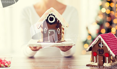 Image of close up of woman showing gingerbread house