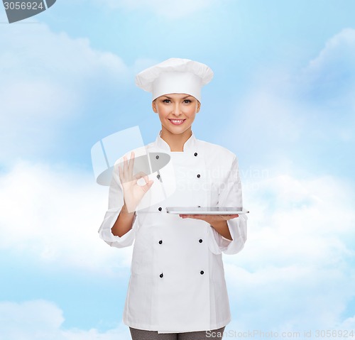 Image of smiling female chef with tablet pc computer