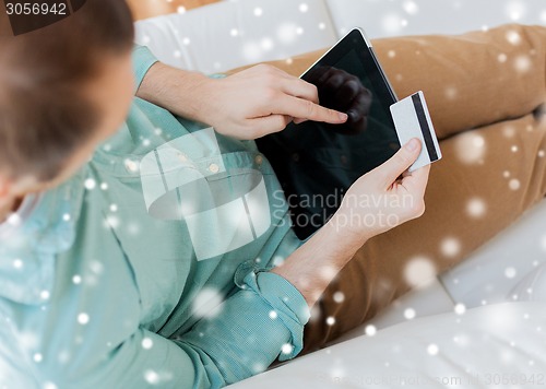 Image of close up of man with tablet pc and credit card