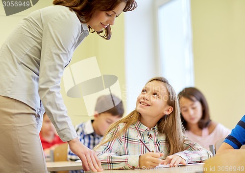 Image of group of school kids writing test in classroom