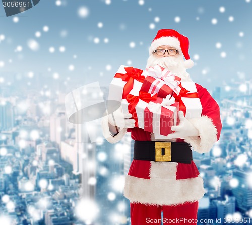 Image of man in costume of santa claus with gift boxes