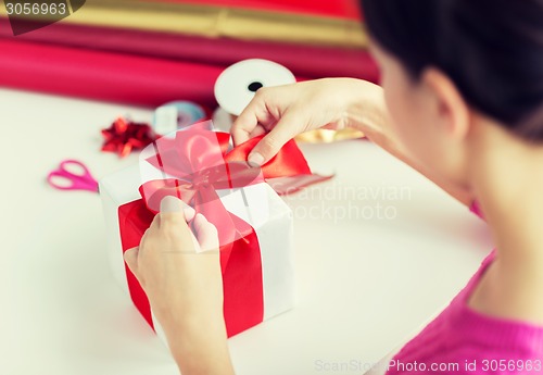 Image of close up of woman decorating christmas presents