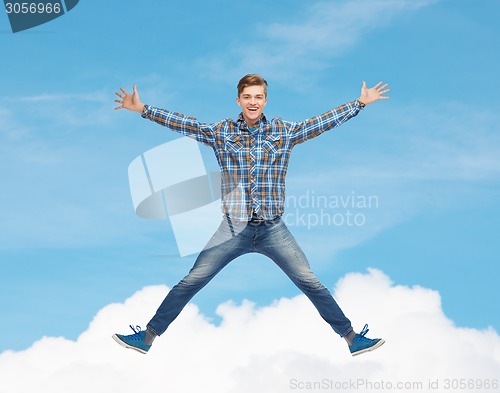 Image of smiling young man jumping in air