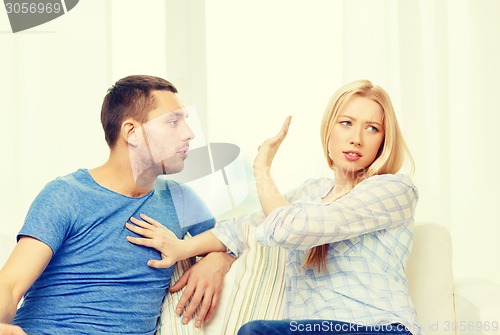 Image of unhappy couple having argument at home