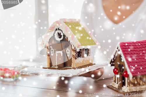 Image of close up of woman showing gingerbread house