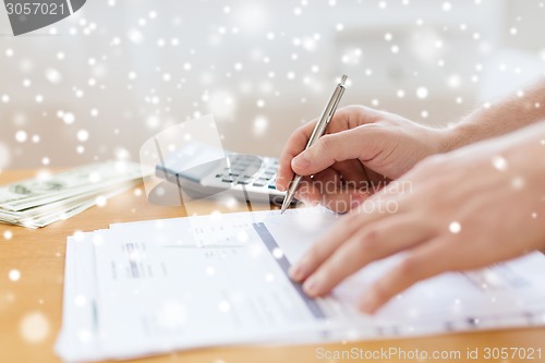 Image of close up of man with papers doing tax report