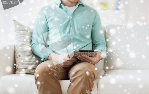 Image of close up of man with tablet pc computer at home