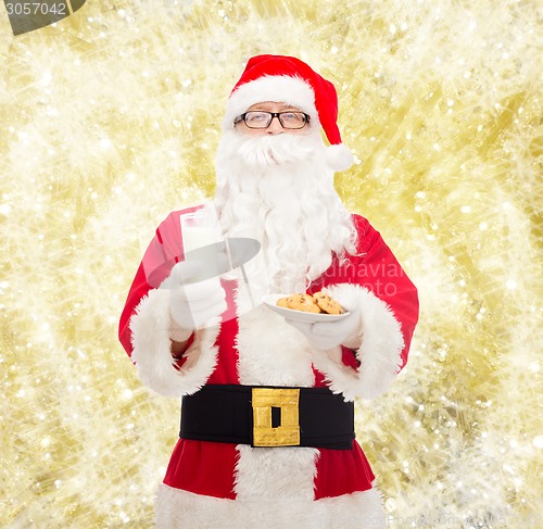 Image of santa claus with glass of milk and cookies
