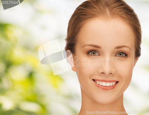 Image of beautiful young woman over green background