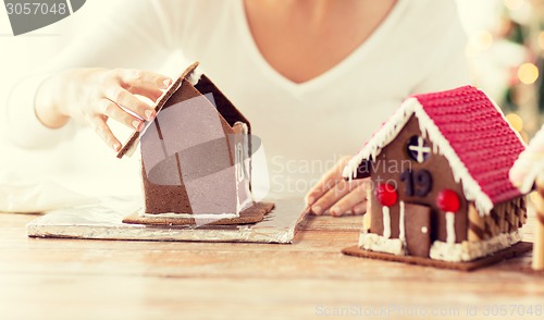 Image of close up of woman making gingerbread houses