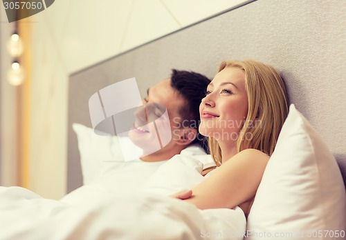 Image of happy couple dreaming in bed