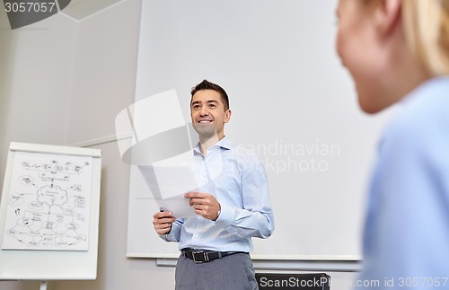 Image of smiling business people meeting in office