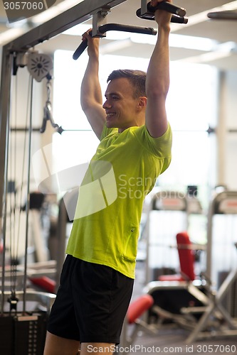 Image of smiling man exercising in gym