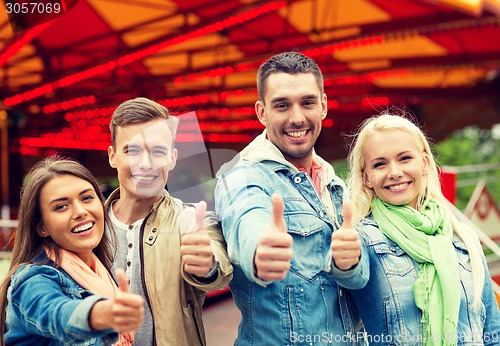 Image of group of smiling friends showing thumbs up