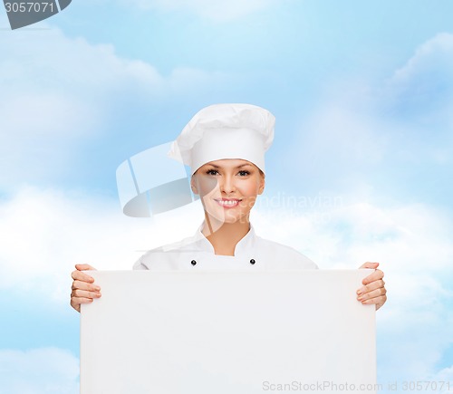 Image of smiling female chef with white blank board