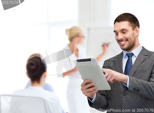 Image of young businessman showing thumbs up gesture