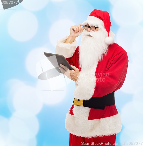 Image of man in costume of santa claus with tablet pc