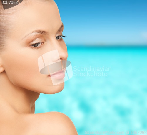 Image of beautiful young woman over blue sky and sea