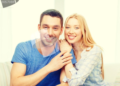 Image of smiling happy couple at home