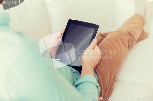 Image of close up of man with tablet pc computer at home