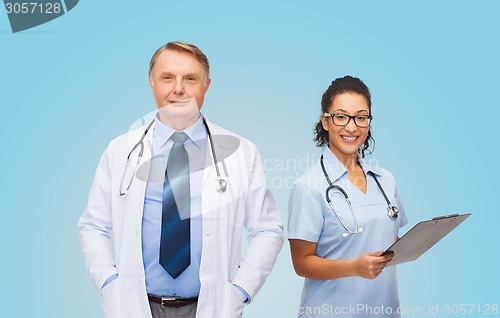 Image of smiling doctors with clipboard and stethoscopes