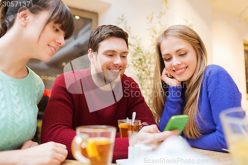 Image of group of friends with smartphone meeting at cafe