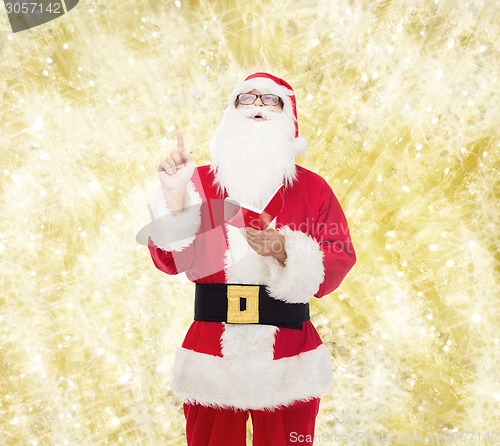 Image of man in costume of santa claus with notepad