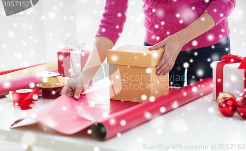 Image of close up of woman decorating christmas presents