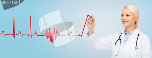 Image of smiling female doctor drawing heartbeat cardiogram