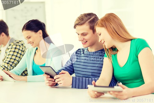 Image of smiling students with tablet pc at school