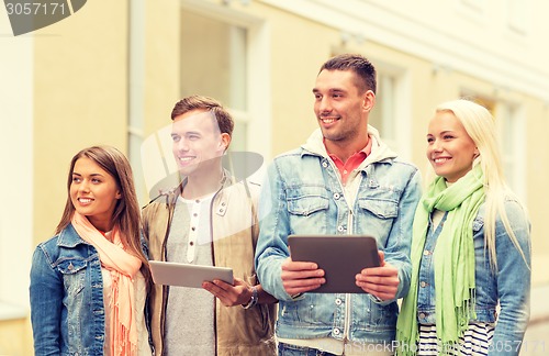 Image of group of smiling friends with tablet pc computers