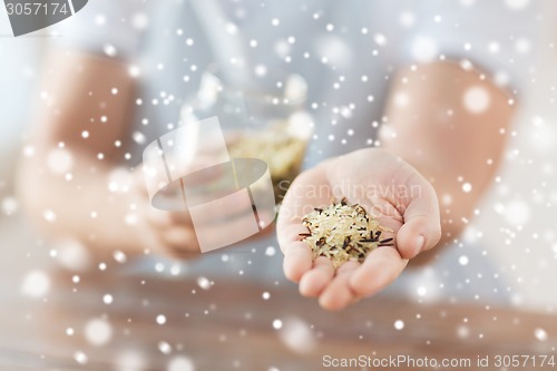 Image of female emptying jar with white and wild black rice