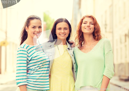 Image of smiling teenage girls with on street